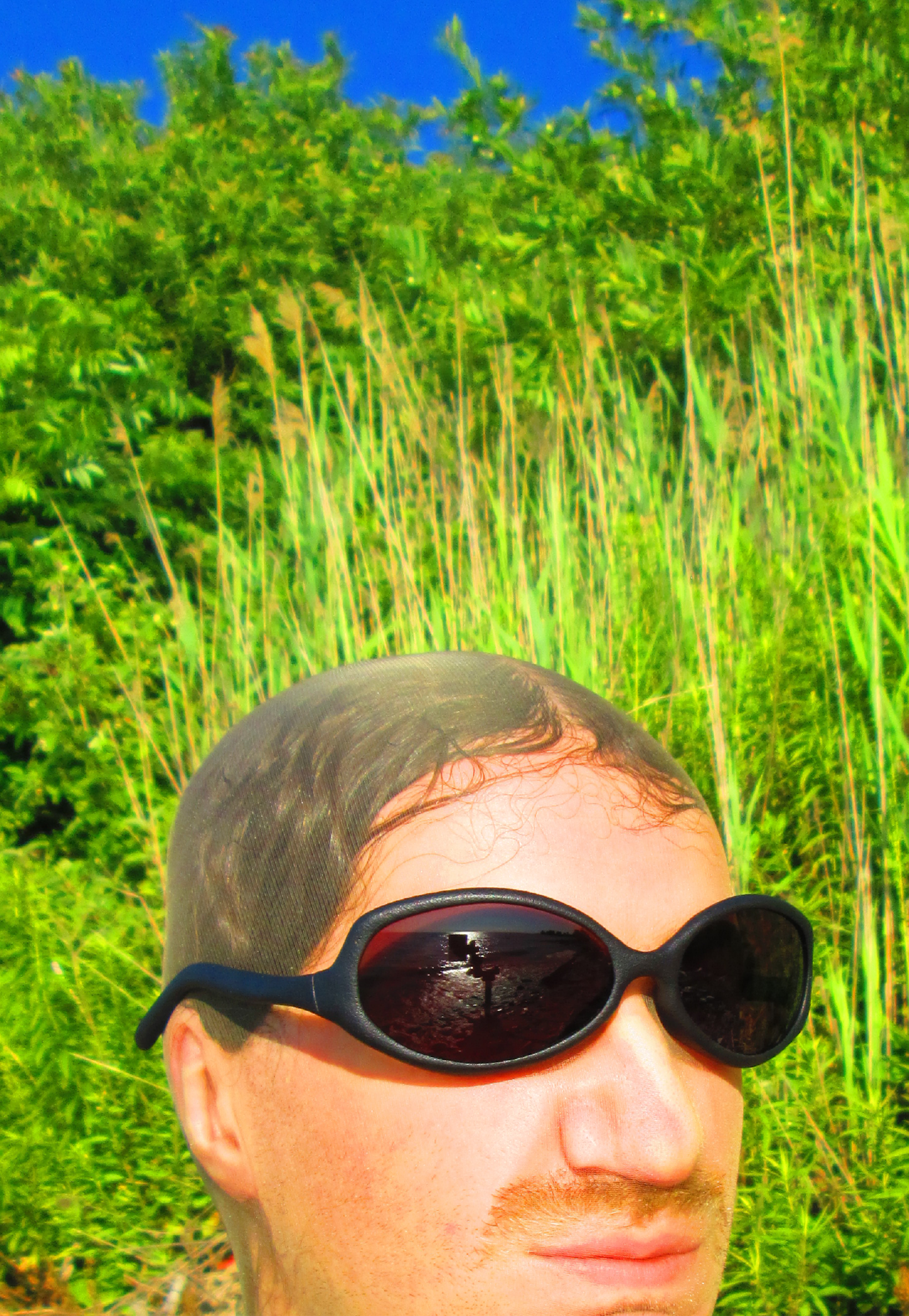 3D render of a bald model wearing black sunglasses with transparent grey lenses